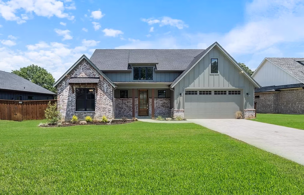Custom home exterior with modern farmhouse design and covered front porch