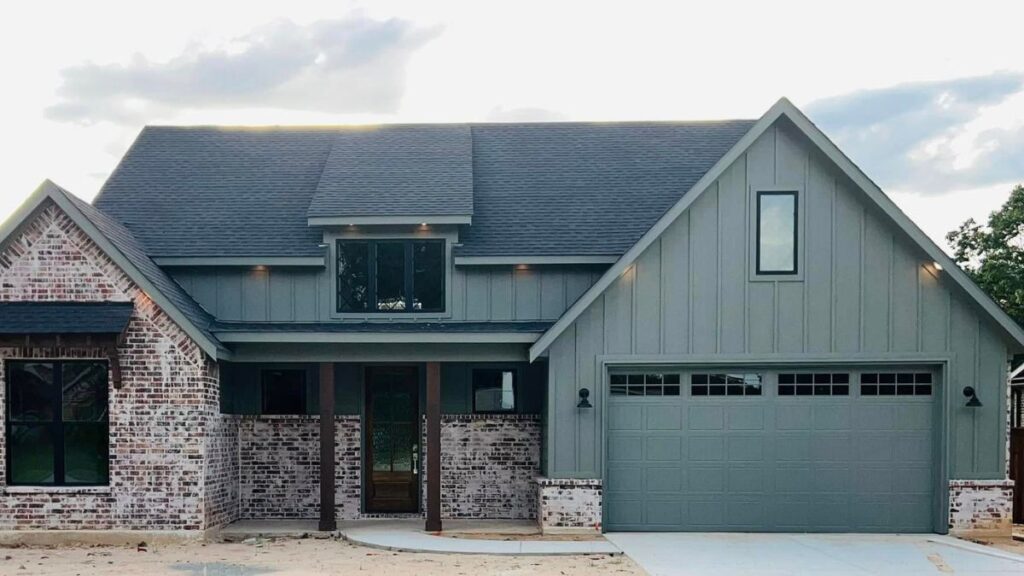 Custom home builder project in Canton TX featuring a modern farmhouse exterior with brick and green siding