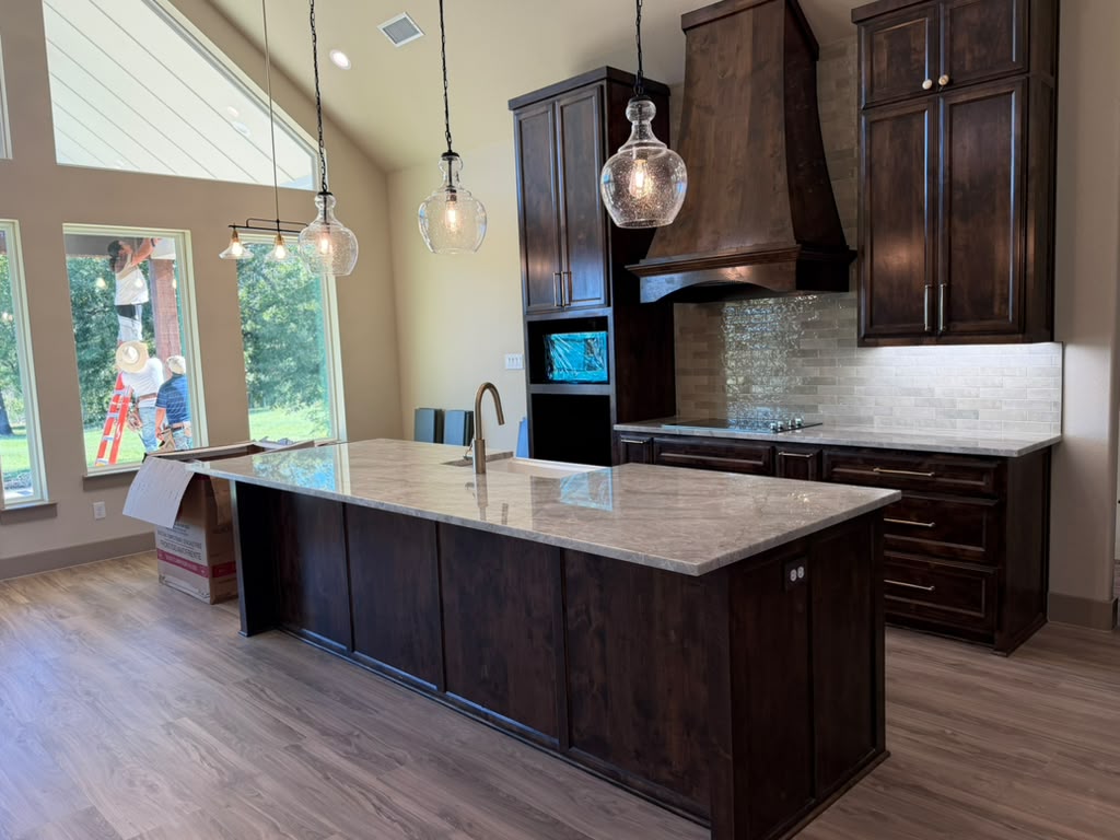 Kitchen remodeling in progress in Canton TX with custom dark cabinetry and natural light windows.